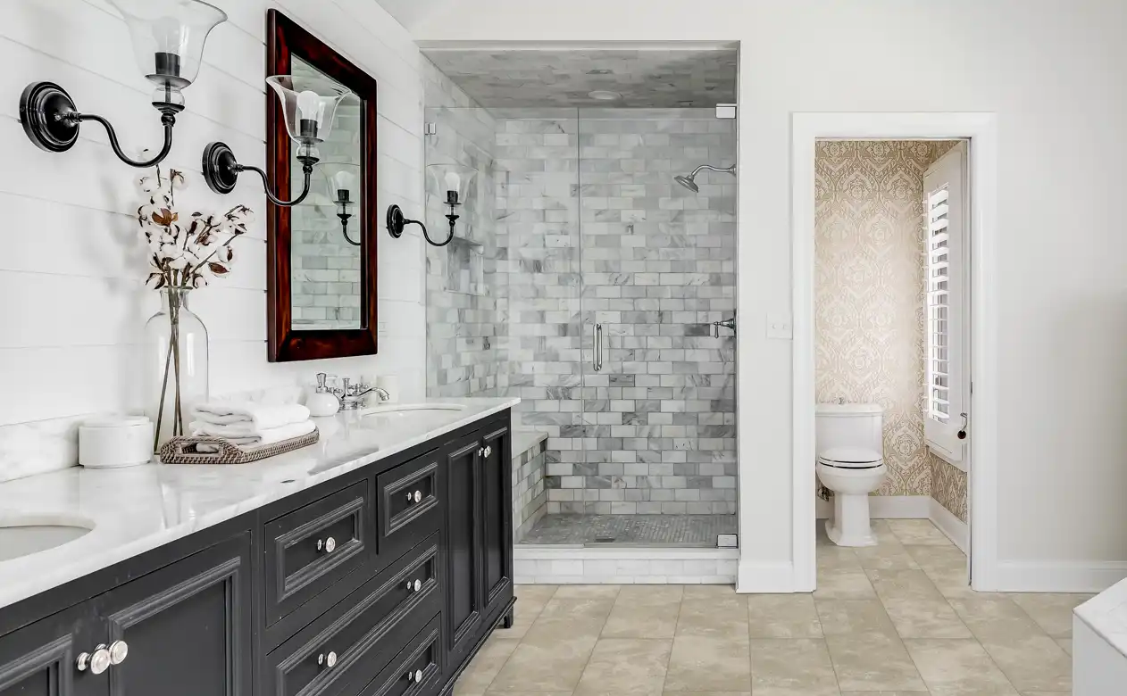 Shower with varying grey subway tile. 